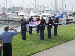 Servicemen carrying the American Flag